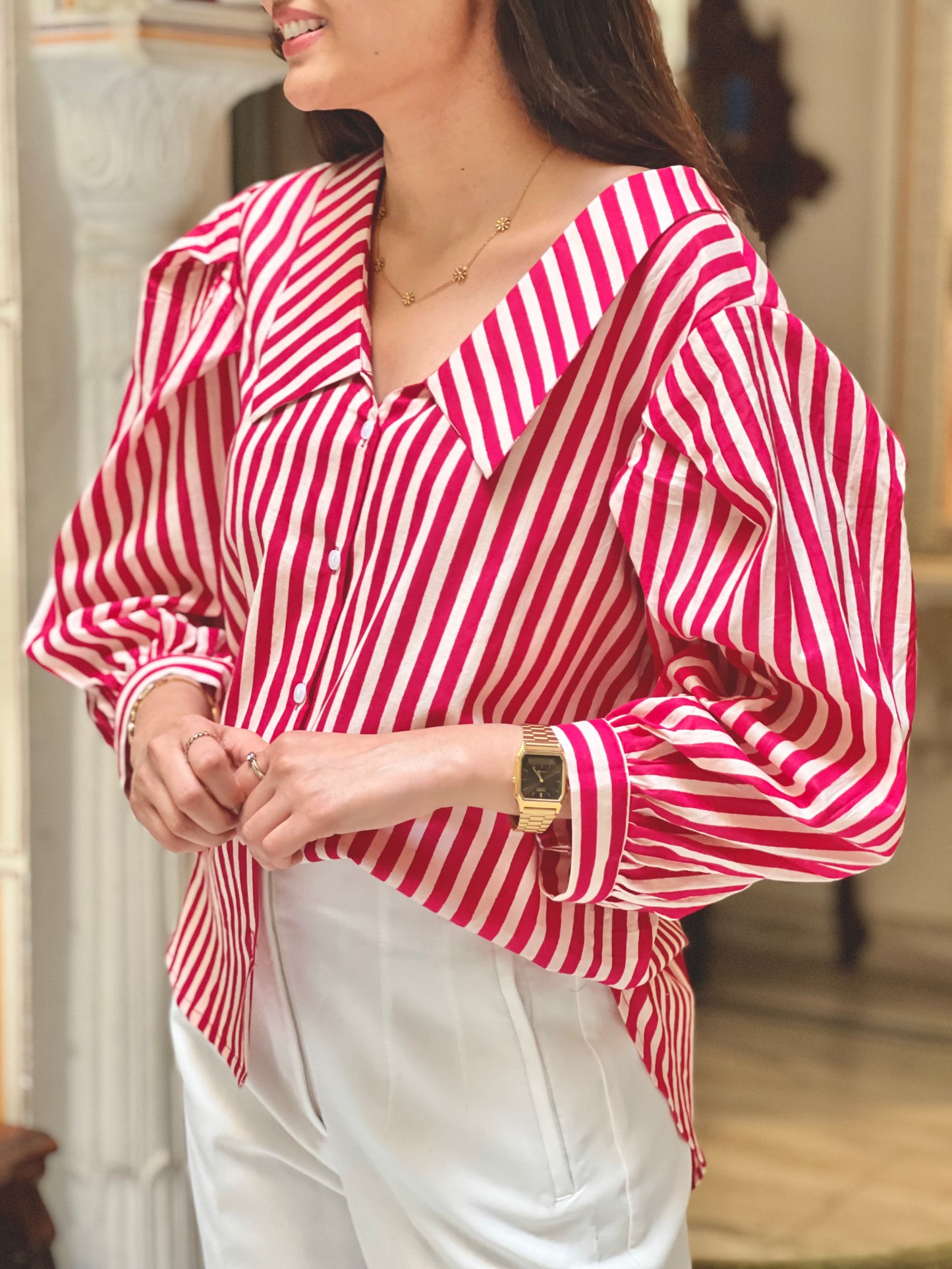 Woman wearing a red and white striped blouse with a blurred background