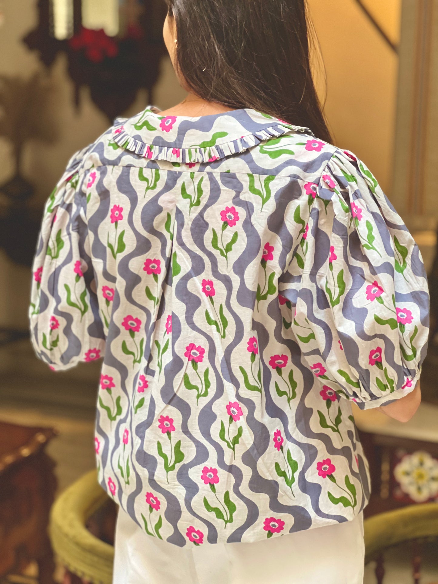 Woman wearing a floral blouse with a blurred background