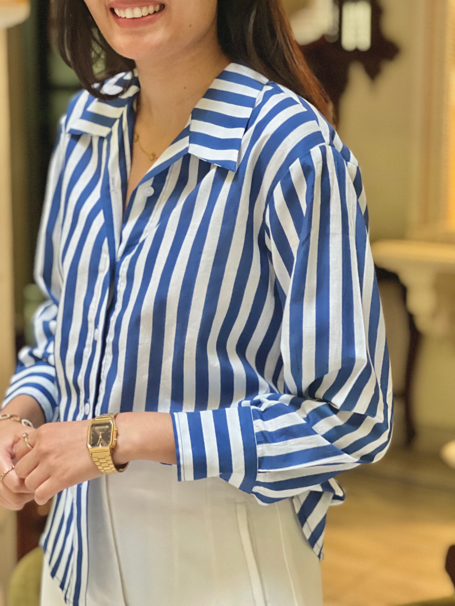 Woman wearing a blue and white striped shirt indoors