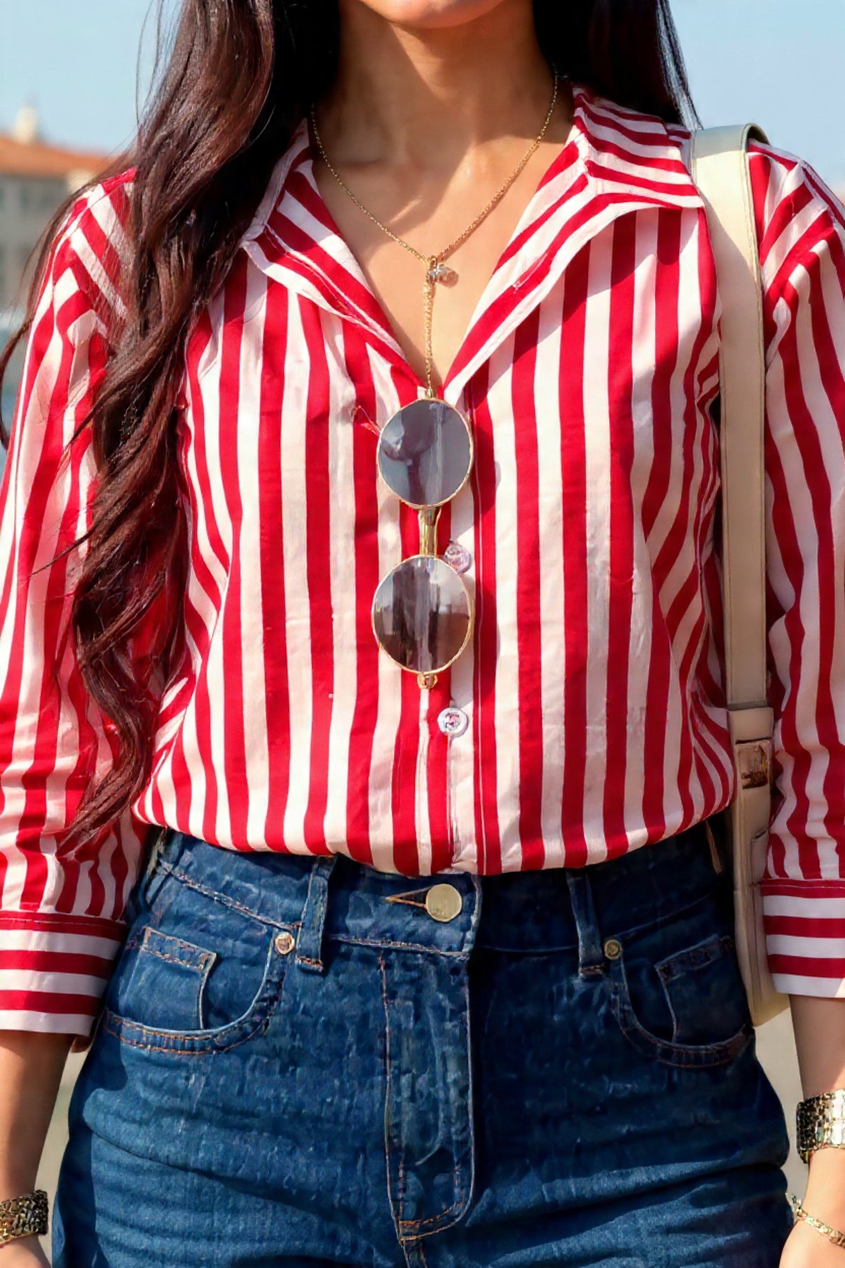 Person wearing a red and white striped shirt with sunglasses on a blue background