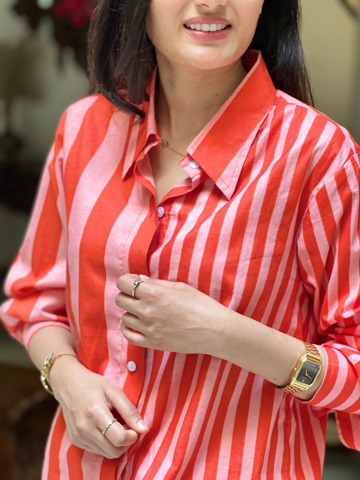 Woman wearing a red and white striped shirt with a blurred background