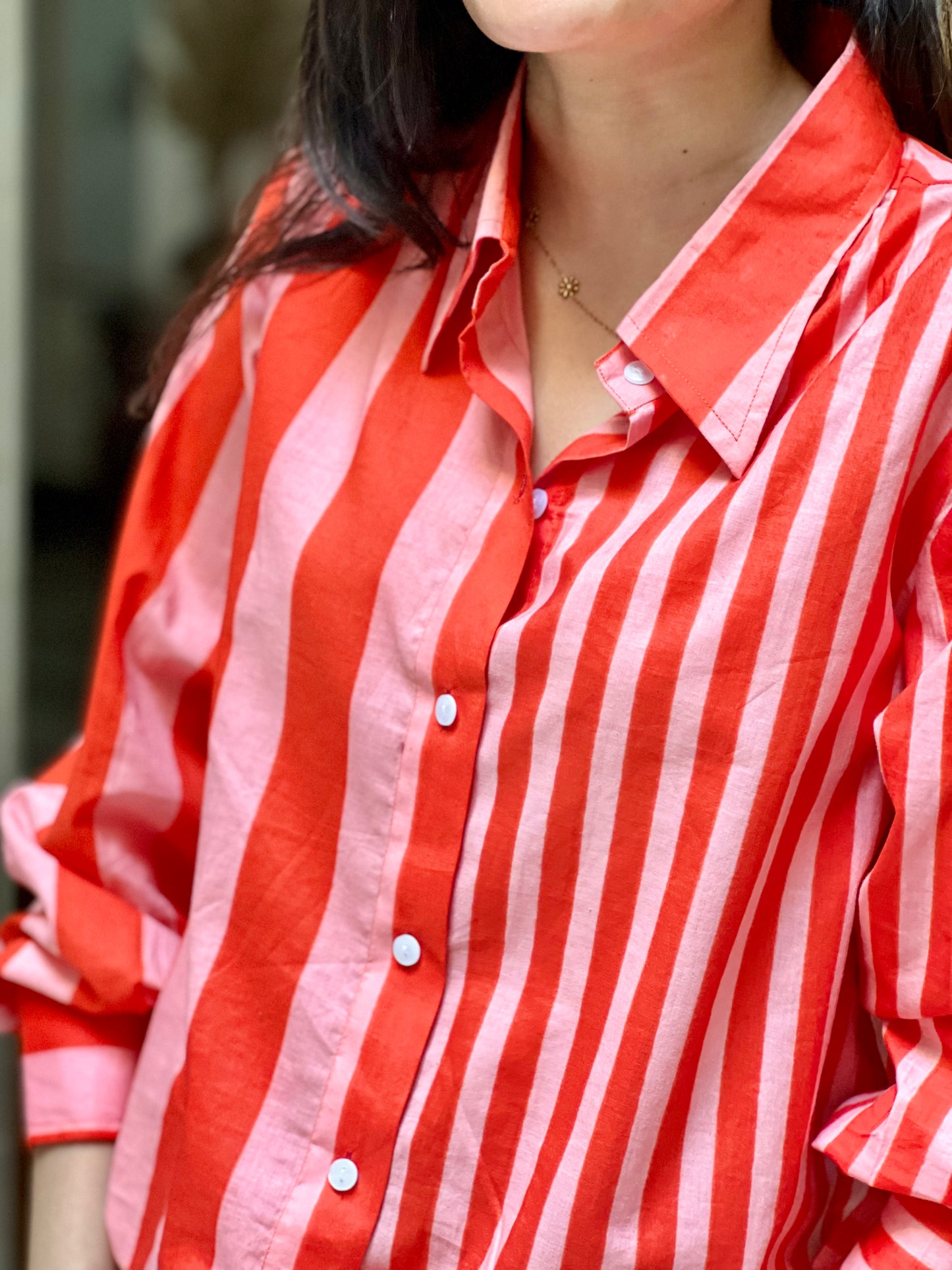 Red and white striped shirt worn by a person