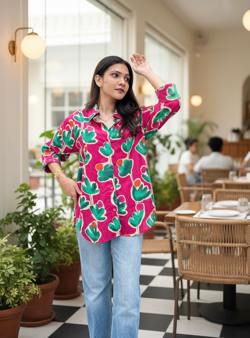Woman wearing a colorful cactus-patterned shirt in a casual indoor setting