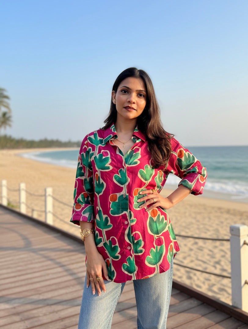 Woman wearing a colorful patterned shirt by the beach