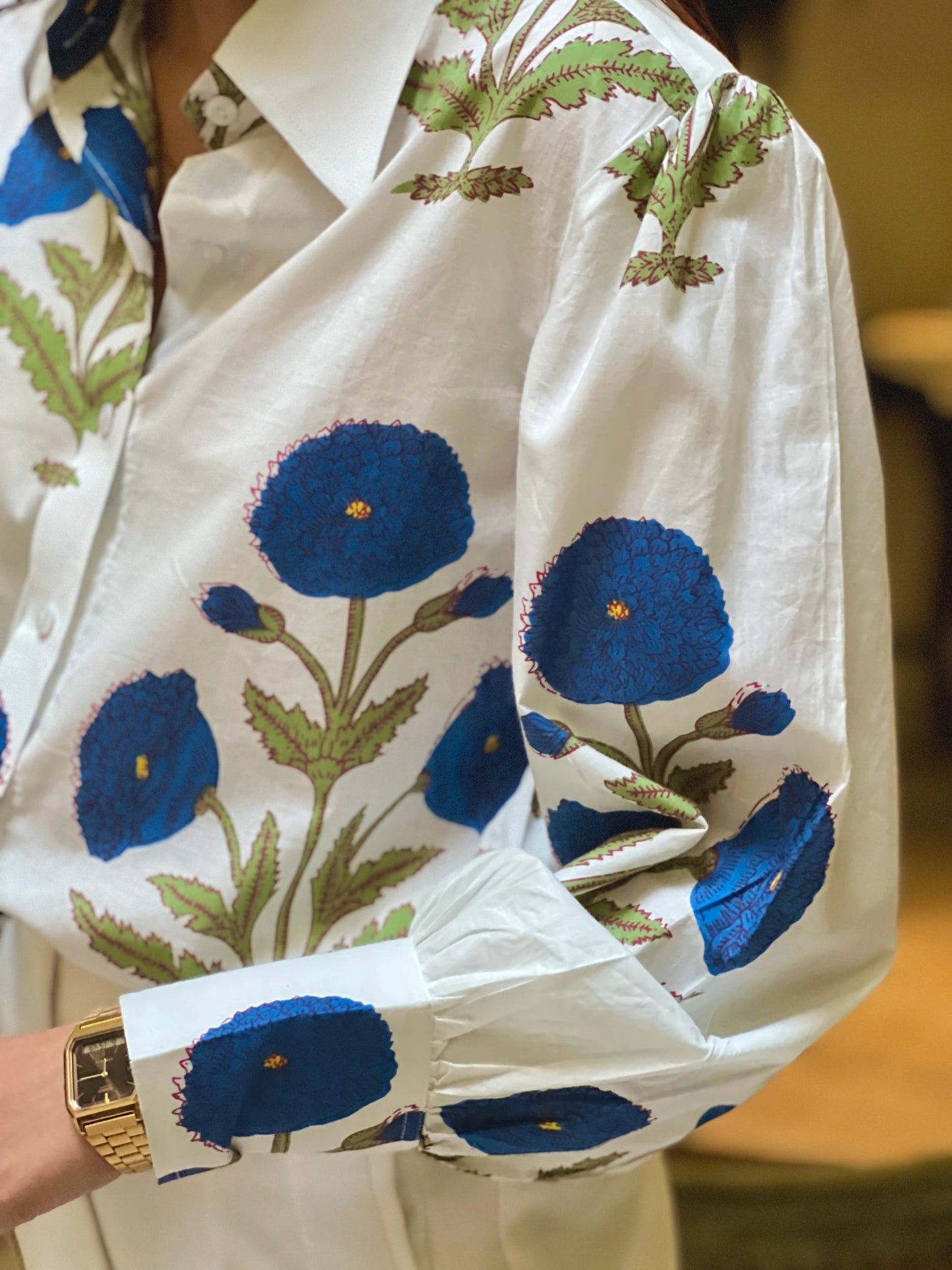 Close-up of a white fabric with blue floral embroidery