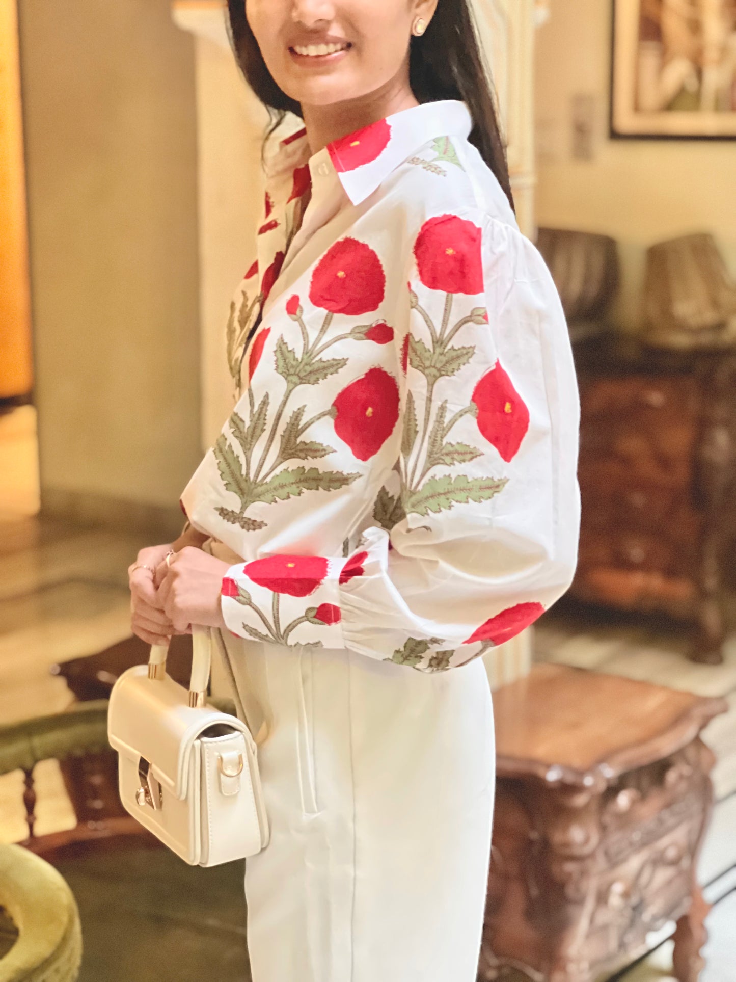 Woman wearing a floral-patterned jacket in an indoor setting