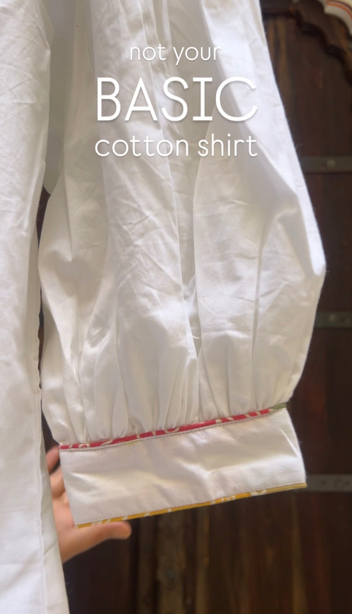 White cotton shirt with text 'not your BASIC cotton shirt' on a blurred background