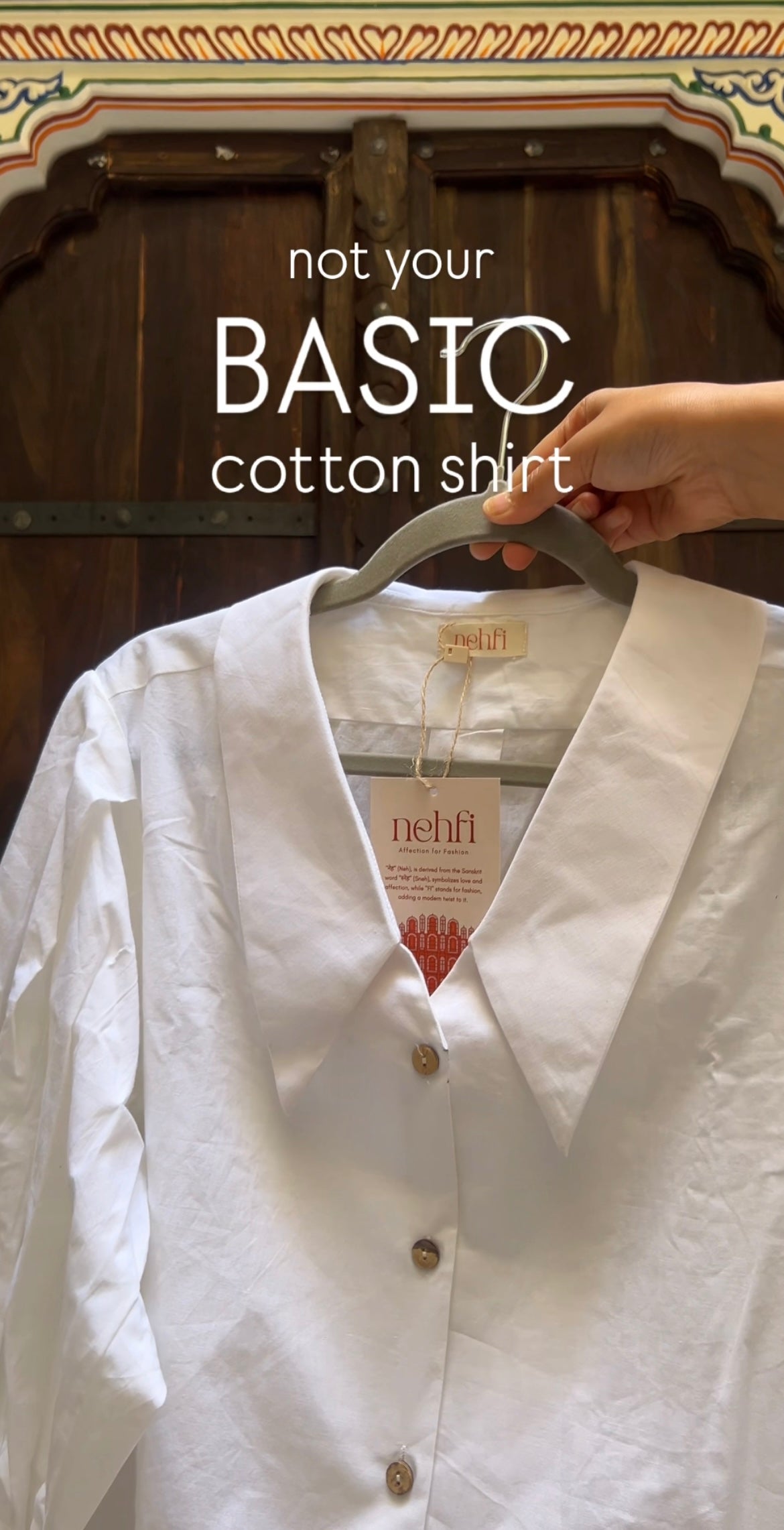 White cotton shirt on a hanger with 'not your BASIC cotton shirt' text and 'nehil' brand label.